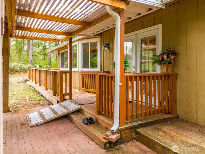 Covered entry to the home from the carport side.