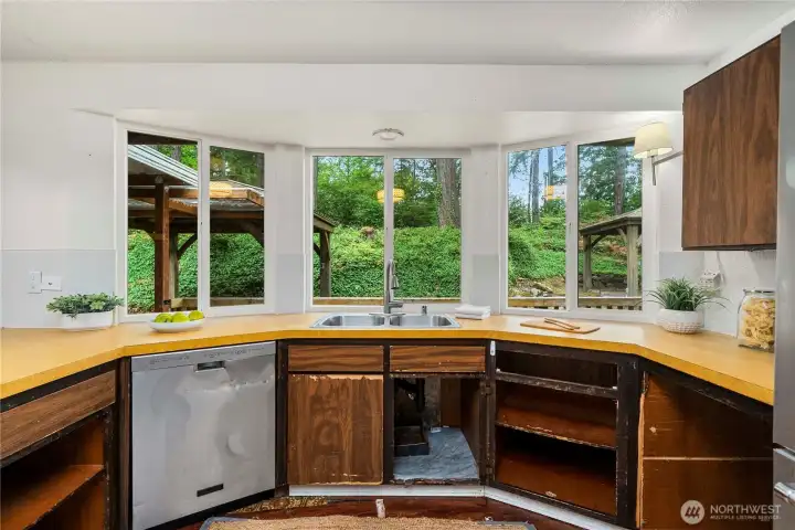 Kitchen windows look out over the yard and toward the gazebo. Don't be surprised to see deer crossing through.
