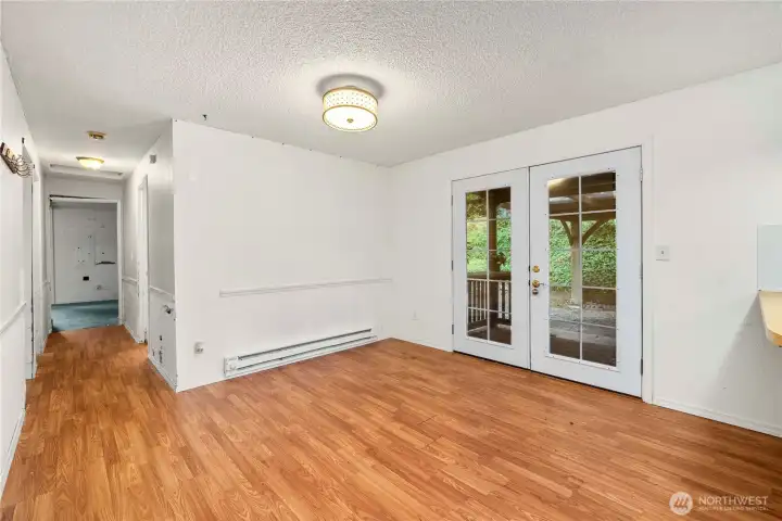 Showing the entry from the carport. This is a 2nd eating area - or it could be an office or lounge area. The baseboard heaters are still connected, but the main heat source are the mini-splits.