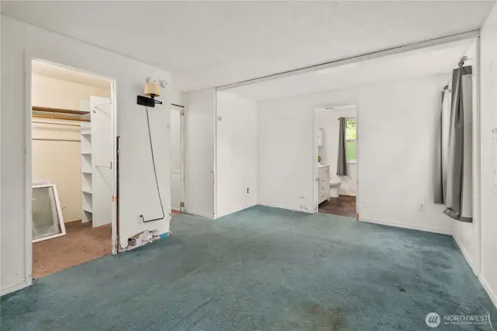 Primary suite from another angle- showing the bathroom and closet.