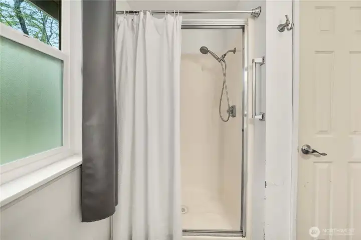 Shower in the primary bath and linen closet.