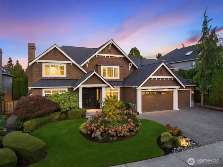 Beautiful curb appeal with professional landscaping and a 3 car garage