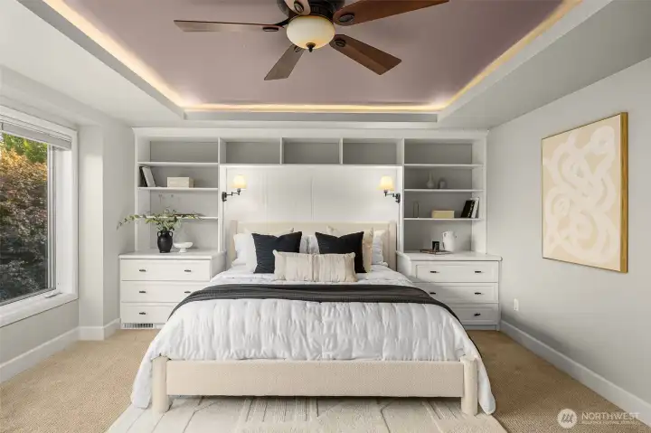 Relax and unwind in this stunning primary suite with custom built-ins and a tray ceiling