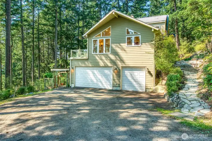 Exterior showing path to front door, and 3 car garage.