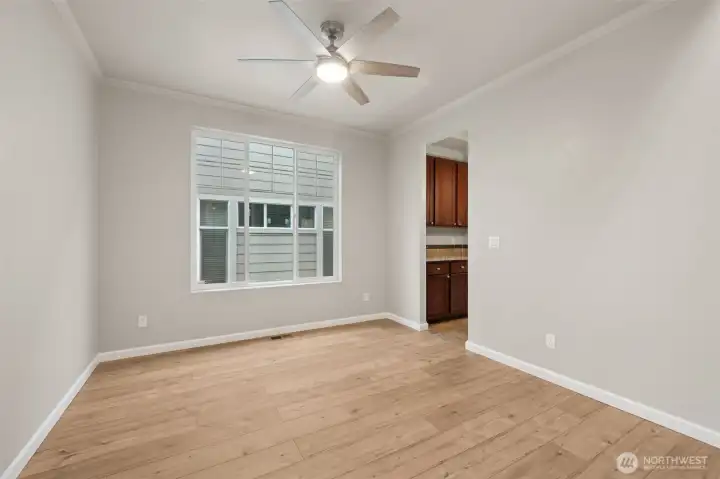 This angle really shows how polished this formal dining room feels. From the entry, your eye is drawn straight across the room to the butler’s pantry, which makes the whole space feel connected and intentional. The oversized window brings in generous natural light, while crisp white millwork and crown molding frame the room and add just the right amount of formality. It’s elegant without feeling stiff, and flexible enough to work as a dining room, front living space, or something in between.