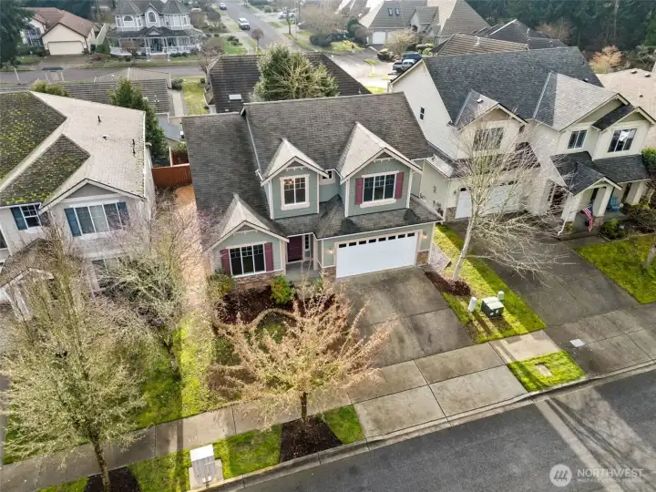 This aerial angle highlights the home’s strong presence on the street. The Craftsman inspired exterior, two car garage, and clean lines all feel cohesive and well maintained. Sidewalks and mature trees frame the setting nicely, and the front yard stays intentionally simple. A new ridge cap on the roof adds peace of mind, showing that the important updates have been handled.