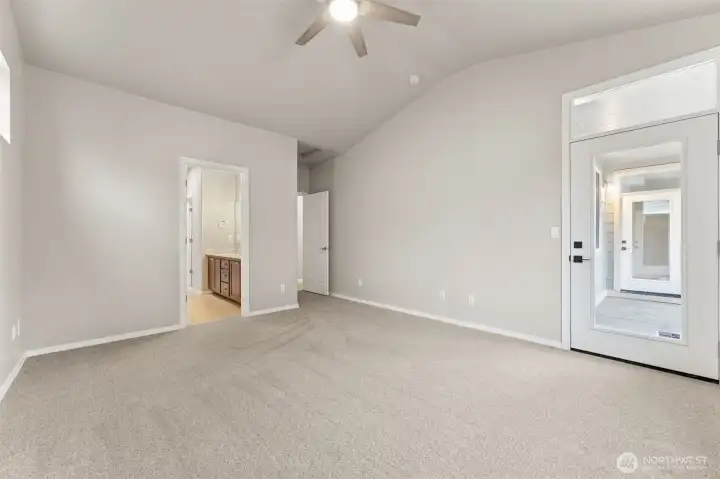 The primary suite gets bonus points for access. A private glass door opens directly to the backyard, complete with an accent window above that keeps the room bright and open. Whether you’re dreaming of a covered patio moment, a quiet morning beverage, or a future hot tub setup, this door makes it easy. Paired with the en suite bath just steps away, the layout feels intentional and indulgent in the best way.