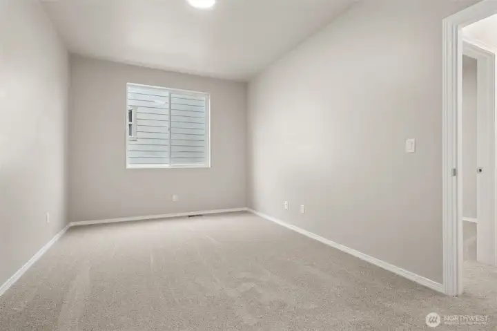 This #4 bedroom is a blank slate in the best way. New carpet, white trim, and a generous window create a bright, calm space that adapts easily to whatever you need it to be. The neutral tones keep things timeless and low stress, and the fresh carpeting throughout the home carries the same clean feel from room to room. Not flashy, just solid and easy to live with.