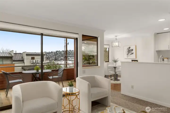 Spacious living area with partial views into the dining area and kitchen