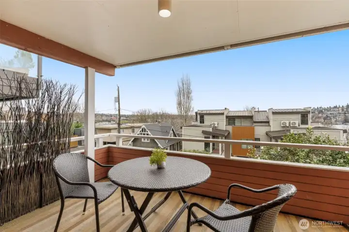 Expansive covered balcony with Lake Union views, perfect for relaxing or entertaining!