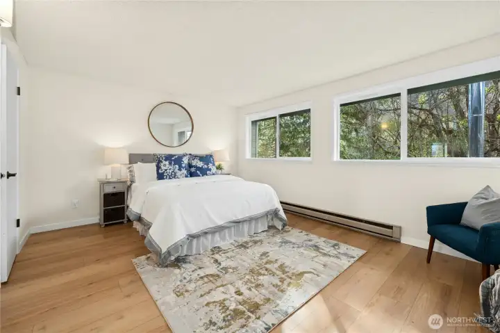 Upstairs primary bedroom is light and bright.