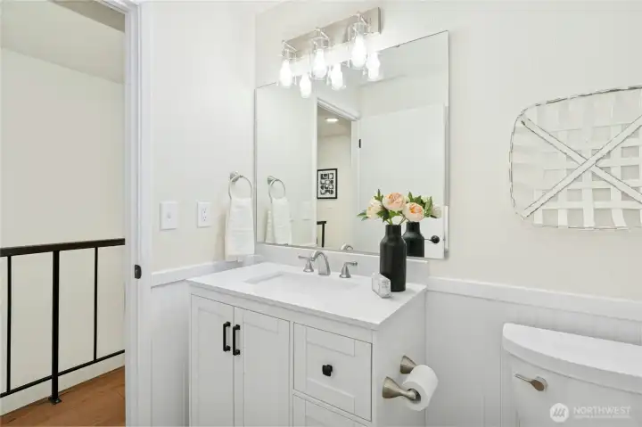 The upstairs full bath has just been updated with a new vanity, lighting and wainscoting.