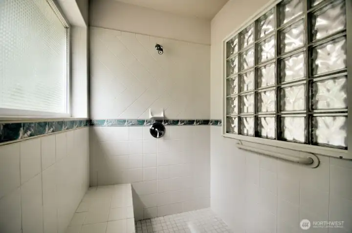 Tile shower in the primary bath.