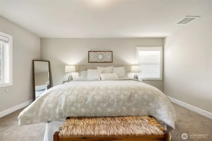 Step upstairs to the Primary bedroom (King size bed shown)