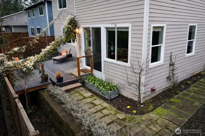 Backyard complete with patio/deck and lots of garden space.  Clematis in full bloom!