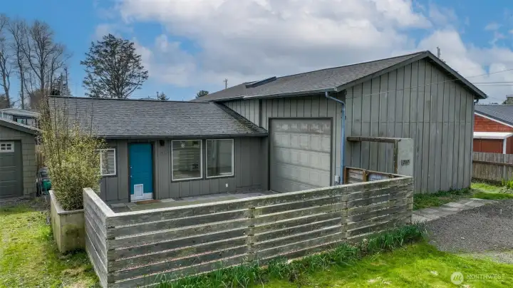 Exterior of the residence. Fenced front courtyard near town in Long Beach, Washington.