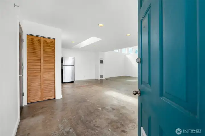 Large open concept living with industrial style concrete flooring.