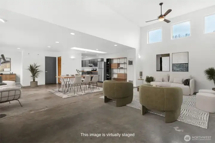 Large open concept living with industrial style concrete flooring. This photo has been virtually staged.