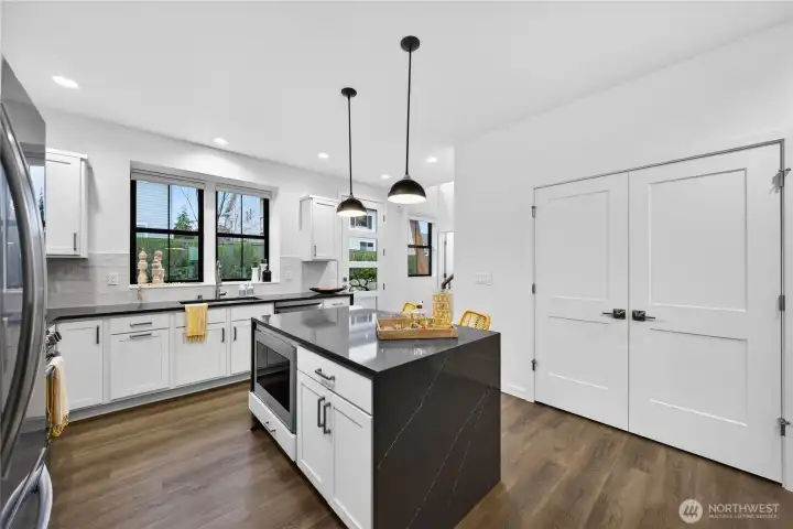 Light and bright with oversized windows in the kitchen and glass entry door.