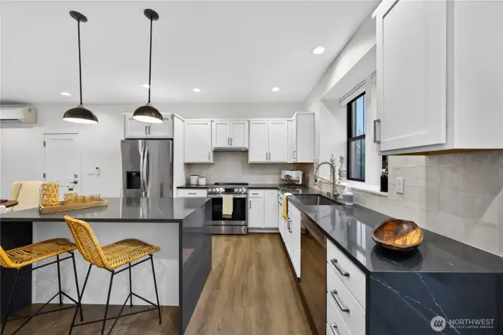 Island kitchen creates extra seating, plenty of upper/lower cabinetry for storage.