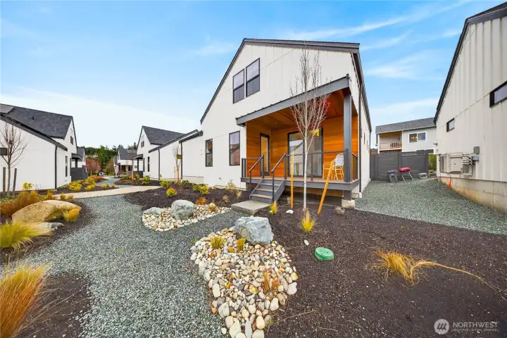 Additional view of the covered porch wrapped in beautiful warm wood.