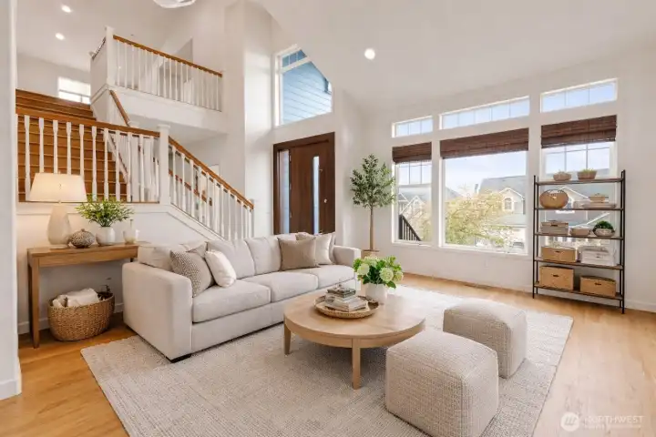 Living room. Bamboo window shades. Staircase leads up to 4 bedrooms including primary suite. (virutally staged)