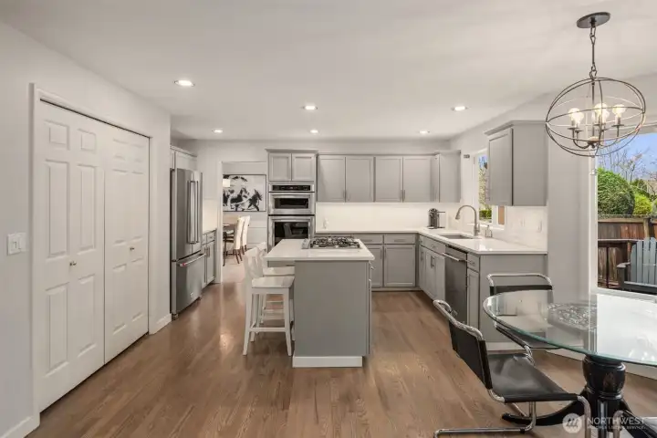 Kitchen features armoire fridge and pantry.