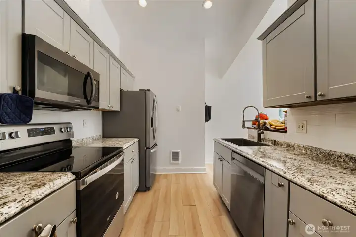 Granite countertops provide a polished finish. Stainless steel appliances elevate the space.