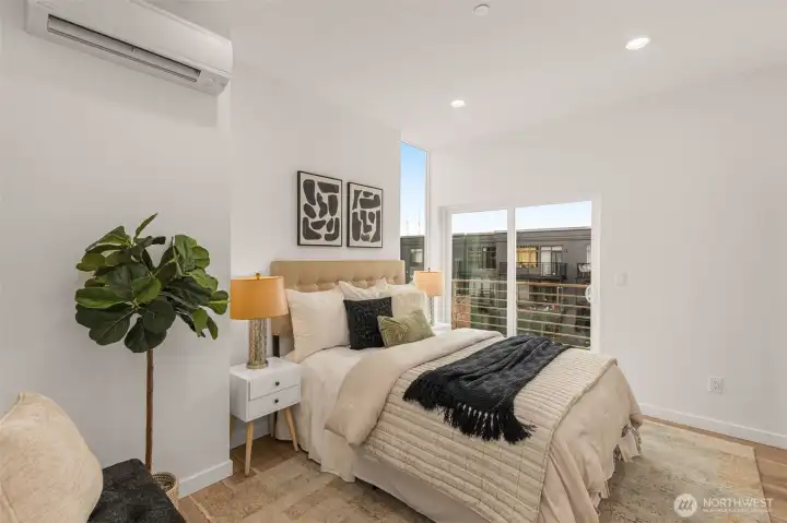 The primary suite is spacious with soft tones and balcony views and perfect for relaxation after a long day.