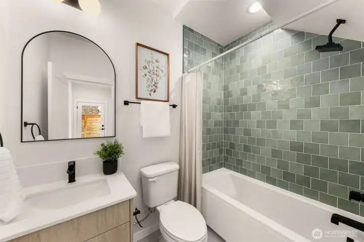 A spa-like vibe with an elegant green tile and matte black fixtures—because even your daily routine deserves a little charm.