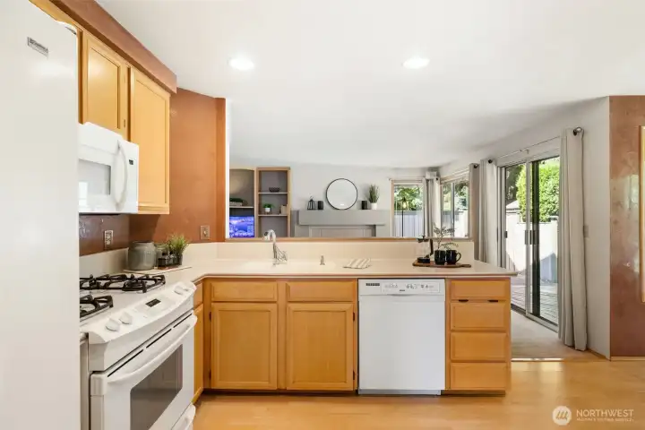 A chef-friendly kitchen featuring ample counter space, warm cabinetry and updated flooring.