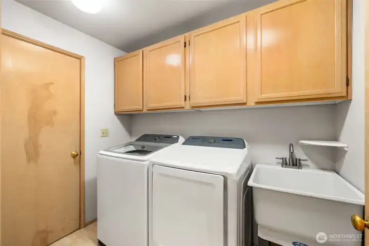 Utility Room is spacious and efficient with storage and garage access.