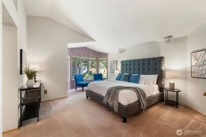 Primary Suite offers spacious retreat with vaulted ceiling.