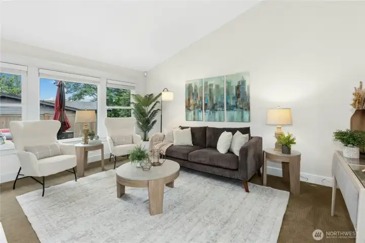 Spacious formal sitting area with abundant natural light, soaring ceilings, and comfortable gathering spaces perfect for relaxing or entertaining guests.