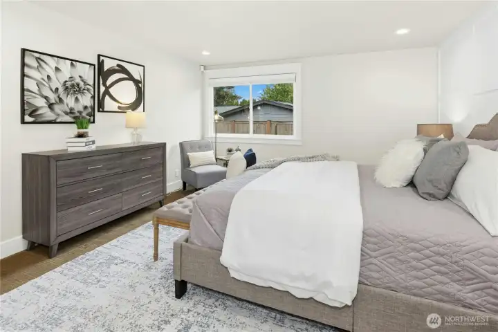 Spacious primary bedroom with modern designer touches, abundant natural light, and calming neutral tones creating a true retreat experience.