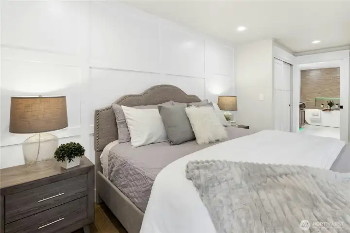 Spacious primary bedroom with modern designer touches, abundant natural light, and calming neutral tones creating a true retreat experience.