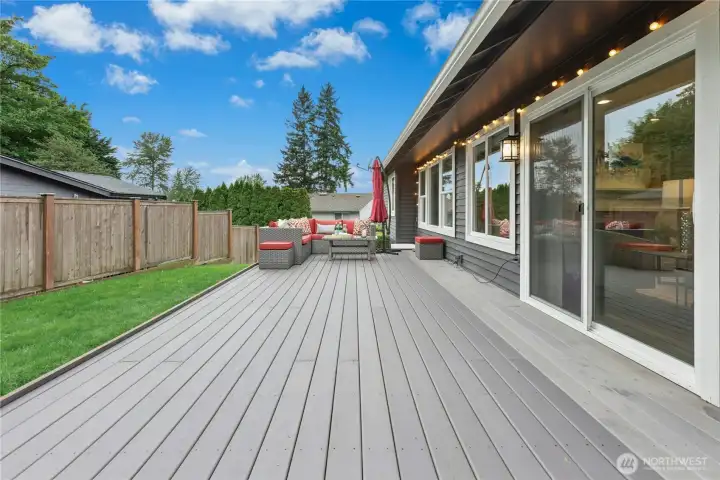 Outdoor Living Space  Private composite deck with modern outdoor seating area, string lighting, and seamless indoor-outdoor flow from the main living spaces.