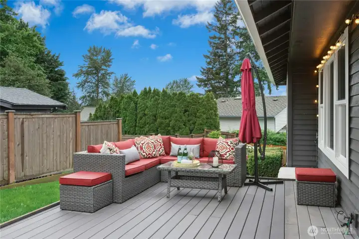 Backyard Entertaining Area  Spacious outdoor lounge area ideal for entertaining guests, enjoying morning coffee, or relaxing in the peaceful backyard setting.