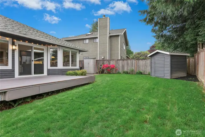 Private Backyard & Storage Shed  Beautifully maintained backyard featuring lush lawn space, mature privacy landscaping, and detached storage shed for added convenience.