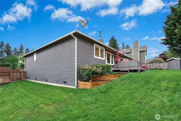 Exterior Rear Elevation  Updated exterior with modern paint palette, expansive deck, and thoughtfully landscaped yard showcases outstanding curb appeal from every angle.