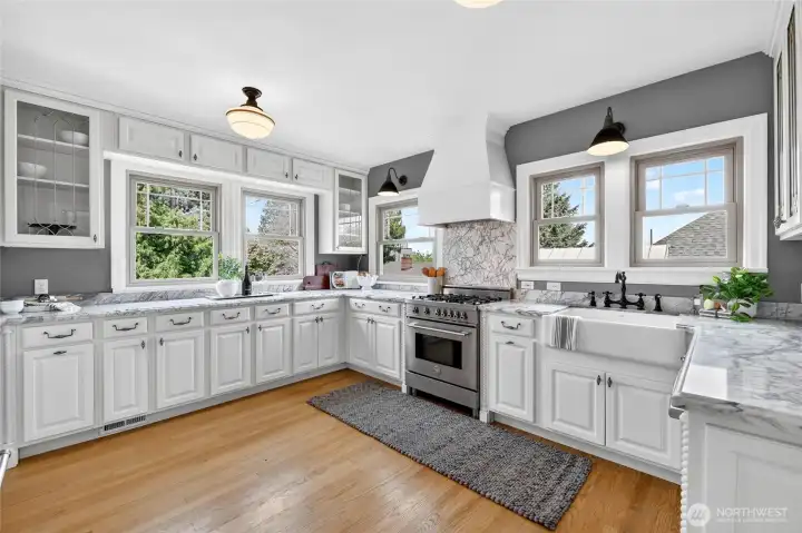 Gleaming marble countertops and tons of cabinetry to store all your kitchen gadgets plus gas range make this kitchen a dream come true for any cook.  There's plenty of room for everyone to gather and help prepare meals together here!