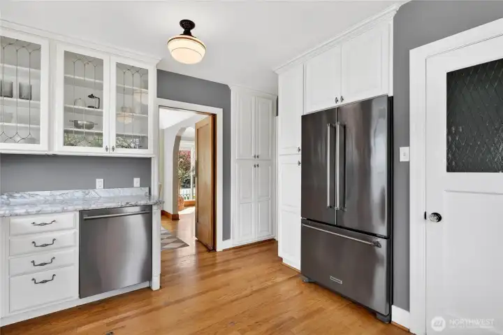 More views of the kitchen.  The door to the right of the refrigerator leads to the stairs to the backyard and garage as well as the basement.