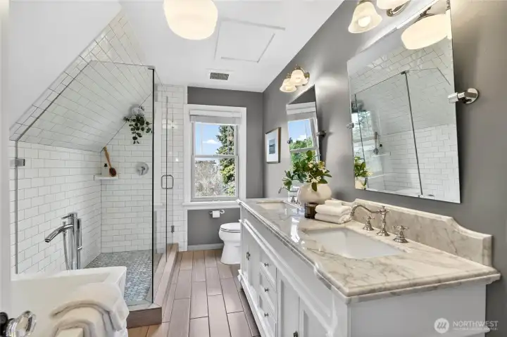 The gorgeous Primary 5-piece bath features free standing tub, double sinks and marble countertops.