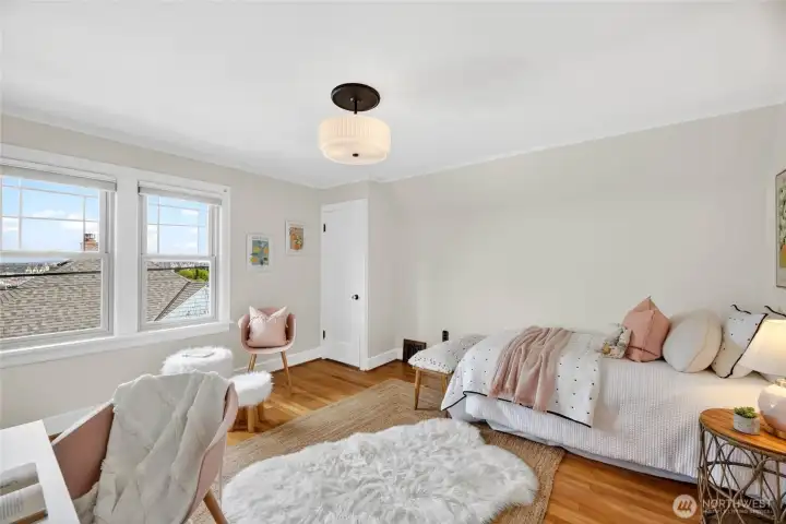 Spacious upstairs bedroom #2 has peek downtown Seattle, Cascade Mts and some water views.