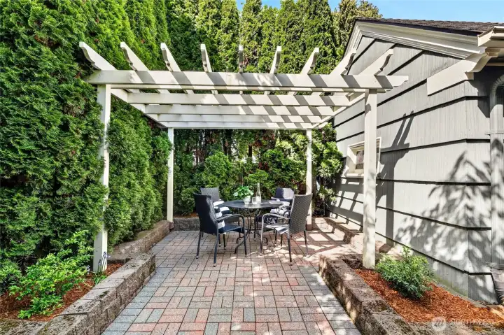 The backyard patio space with pergola is a great place for gathering with friends and family.