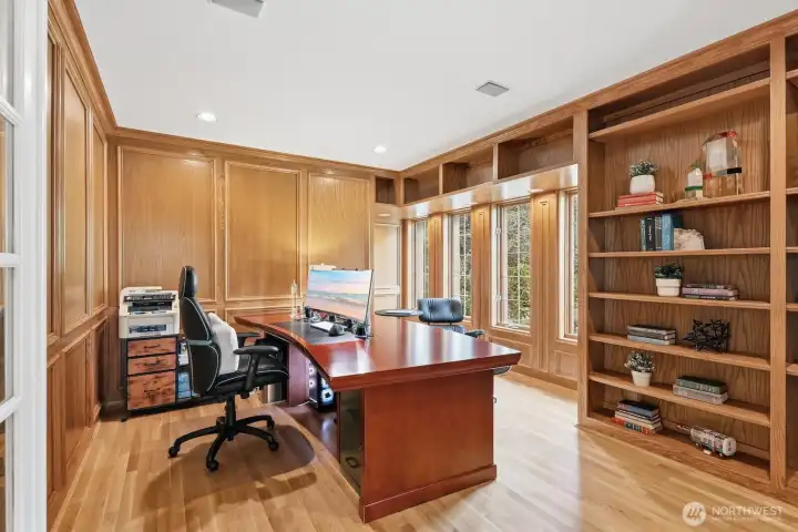 A richly appointed cherry-paneled library/study offers a sophisticated workspace.