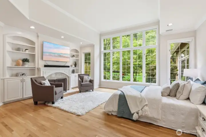 The primary suite is a sanctuary unto itself, complete with lofty ceilings, a marble-surround gas fireplace, and an expansive walk-in closet.