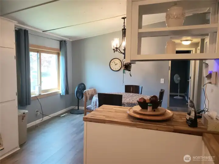 Another Picture of the Spacious Open Bright Kitchen with All White Cabinets, Newer Counter Tops, Newer Stainless Appliances, Interior Paint and Vinyl Plank Flooring.