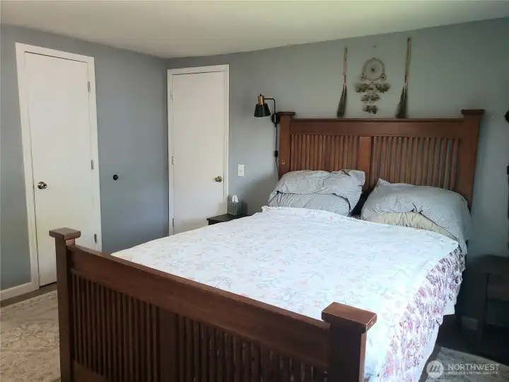 A Picture of the Huge Primary Master Bedroom Showing New Interior Paint, White Painted Trim and Vinyl Plank Flooring.