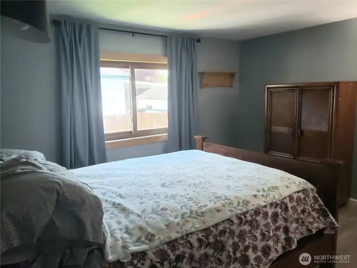 A Different View of the A Huge Primary Master Bedroom Showing New Interior Paint, White Painted Trim and Vinyl Plank Flooring.